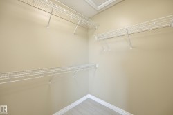 Walk-in closet with multiple levels of wire shelving - 