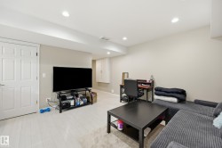 Recessed lighting illuminates this bright space featuring light wood-finish flooring and neutral wall tones - 