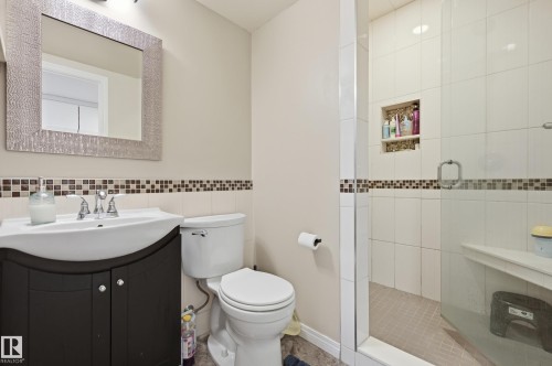 Shower with glass enclosure, integrated bench, and tiled niche - 1 Southfork Close, Leduc, AB - Indoor Photo Showing Bathroom