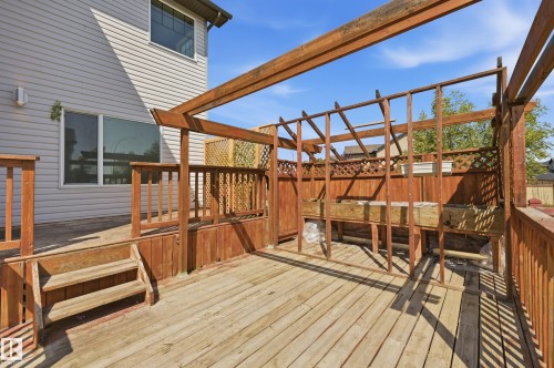 Multi-level wood deck featuring integrated planters and partially framed pergola structure - 1 Southfork Close, Leduc, AB - Outdoor With Deck Patio Veranda With Exterior