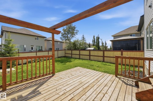 Expansive wood deck with a pergola frame, overlooking a private fenced yard with a manicured lawn - 1 Southfork Close, Leduc, AB - Outdoor With Deck Patio Veranda