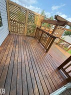 Expansive wood deck with lattice privacy screening and a pergola - 