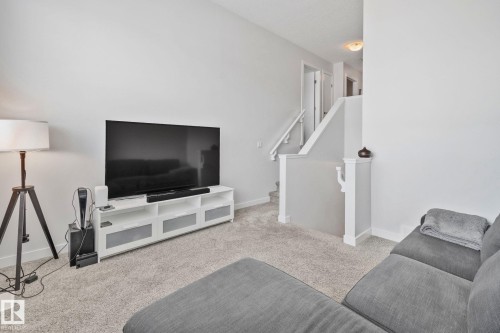 Spacious living area featuring light gray carpeting and neutral wall tones - 249 39A Avenue, Edmonton, AB - Indoor Photo Showing Other Room