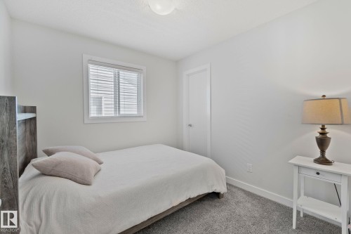 Bedroom featuring light gray carpeting, neutral wall paint, a window with horizontal blinds, and a white interior door - 249 39A Avenue, Edmonton, AB - Indoor Photo Showing Bedroom