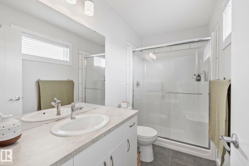 Double vanity with integrated sinks and chrome fixtures - 249 39A Avenue, Edmonton, AB - Indoor Photo Showing Bathroom