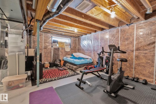 Basement area featuring exposed wood joists, ductwork, and partial insulation - 249 39A Avenue, Edmonton, AB - Indoor Photo Showing Gym Room
