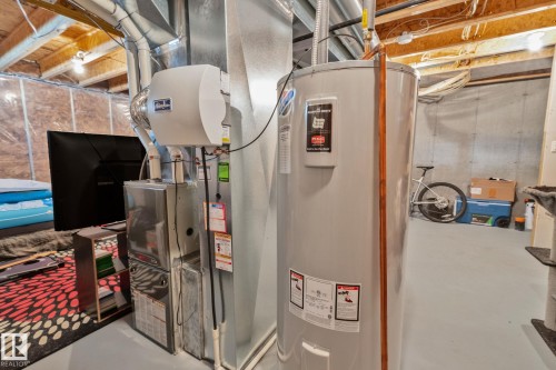 Basement utility area featuring a water heater, furnace, and whole-home humidifier - 249 39A Avenue, Edmonton, AB - Indoor Photo Showing Basement