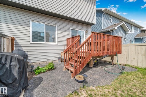 Exterior deck with wood railings and stairs accessing a gravel patio area - 249 39A Avenue, Edmonton, AB - Outdoor With Exterior