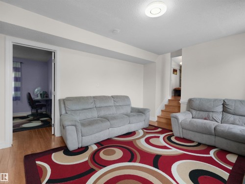 Recessed ceiling light fixture and light wood-finish flooring - 15603 122 Street Nw, Edmonton, AB - Indoor Photo Showing Living Room