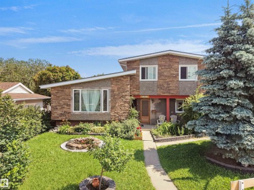 Multi-level residence featuring a stone and textured siding exterior - 15603 122 Street Nw, Edmonton, AB - Outdoor