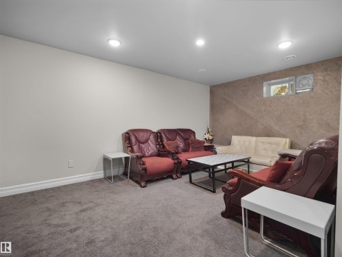 Versatile lower-level room featuring recessed lighting, a window, and textured accent wall - 15603 122 Street Nw, Edmonton, AB - Indoor Photo Showing Basement