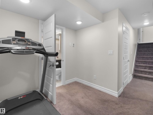 Carpeted room with recessed lighting and a white trim package - 15603 122 Street Nw, Edmonton, AB - Indoor