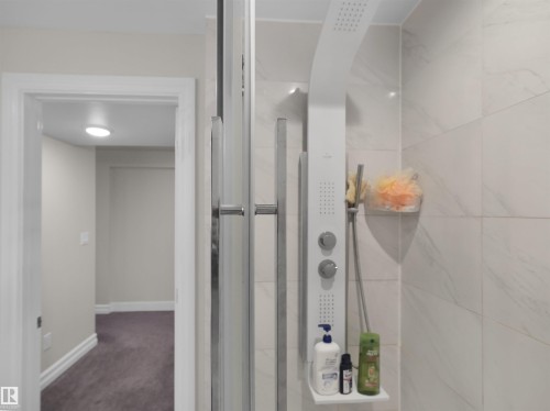 Shower enclosure featuring a multi-function shower panel with integrated shelving - 15603 122 Street Nw, Edmonton, AB - Indoor Photo Showing Bathroom