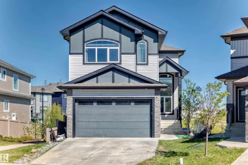 Contemporary home exterior featuring a two-car garage, stone accents, and a mixed siding facade - 2464 15 Avenue Nw, Edmonton, AB - Outdoor With Facade