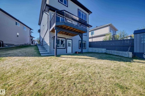 Rear exterior with light gray siding and dark trim - 2464 15 Avenue Nw, Edmonton, AB - Outdoor