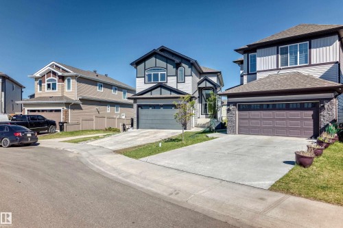 Two-story residence featuring a gray exterior with dark trim accents and an attached garage - 2464 15 Avenue Nw, Edmonton, AB - Outdoor With Facade