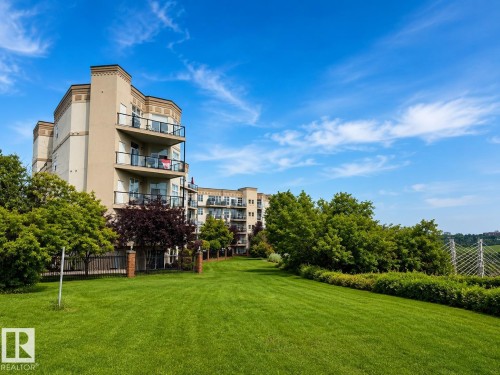 Multi-story building featuring tan and cream exterior finishes with stacked balconies - #412 9503 101 Av Nw, Edmonton, AB - Outdoor With Balcony