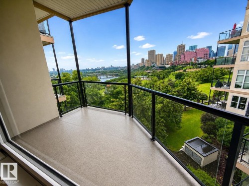 Private balcony with contemporary glass railing and textured flooring - #412 9503 101 Av Nw, Edmonton, AB - Outdoor With Balcony With View With Exterior