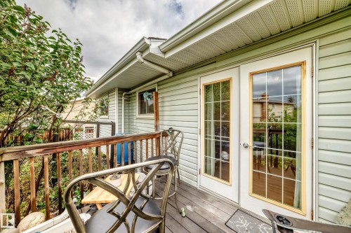 Deck with wood railing and flooring, featuring white French doors with divided lites - 1116 39 Street Nw, Edmonton, AB - Outdoor With Deck Patio Veranda With Exterior