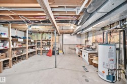Unfinished basement featuring exposed ceiling joists and concrete flooring - 