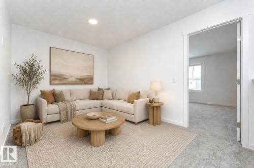 Bright living area featuring a neutral color palette, recessed lighting, and a wide entryway - 6269 175A Avenue Nw, Edmonton, AB - Indoor Photo Showing Living Room
