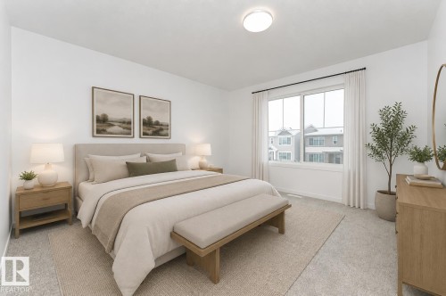 Spacious room featuring neutral carpeting, a large window with white trim, and a ceiling-mounted light fixture - 6269 175A Avenue Nw, Edmonton, AB - Indoor Photo Showing Bedroom