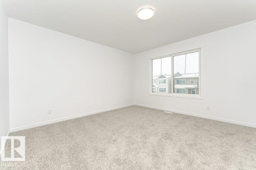 Room with light gray carpeting, white walls, and a single window with a white frame - 6269 175A Avenue Nw, Edmonton, AB - Indoor Photo Showing Other Room