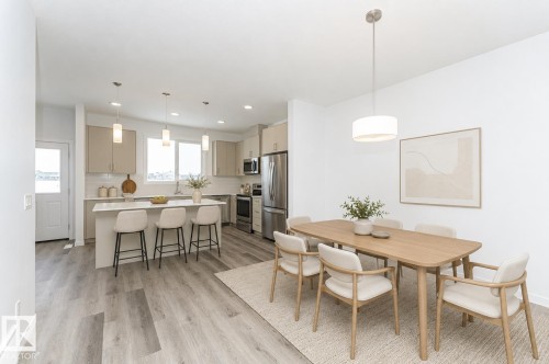 Open-concept living space featuring wood-finish flooring - 6269 175A Avenue Nw, Edmonton, AB - Indoor Photo Showing Dining Room