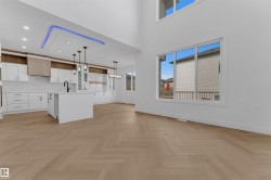 Open-concept living area featuring high ceilings and expansive windows - 