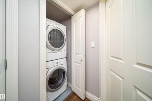 Dedicated laundry closet featuring a stacked washer and dryer unit - 11342 79 Avenue, Edmonton, AB - Indoor Photo Showing Laundry Room
