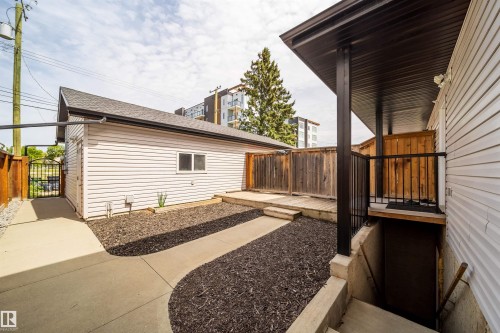 Detached garage with horizontal white siding and a sloped shingle roof - 11342 79 Avenue, Edmonton, AB - Outdoor With Exterior