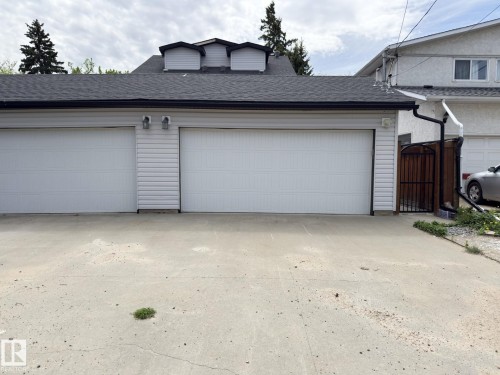 Two-car detached garage with white paneled doors and a black shingle roof - 11342 79 Avenue, Edmonton, AB - Outdoor With Exterior