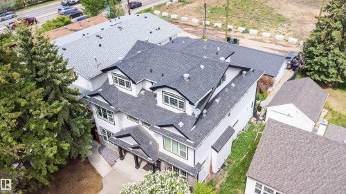 Two-story residence featuring a dark shingle roof, white siding, and black trim windows - 11342 79 Avenue, Edmonton, AB - Outdoor