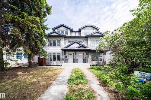 Contemporary duplex with light-colored siding and dark trim accents - 11342 79 Avenue, Edmonton, AB - Outdoor With Facade