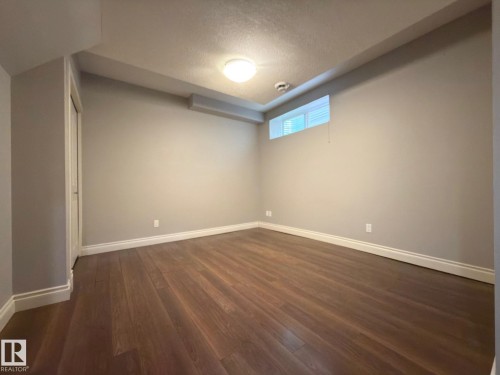 Wood-finish flooring, recessed lighting, and a white trim package - 11342 79 Avenue Nw, Edmonton, AB - Indoor Photo Showing Other Room