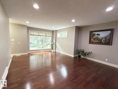 Wood-finish flooring, recessed lighting, expansive windows, and a neutral wall palette - 11342 79 Avenue Nw, Edmonton, AB - Indoor