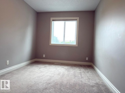 Neutral tone walls with white trim, a single window, and wall-to-wall carpeting - 11342 79 Avenue Nw, Edmonton, AB - Indoor Photo Showing Other Room