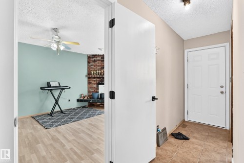 Entryway featuring tile flooring and a white paneled door - 1928 68 Street Nw, Edmonton, AB - Indoor Photo Showing Other Room