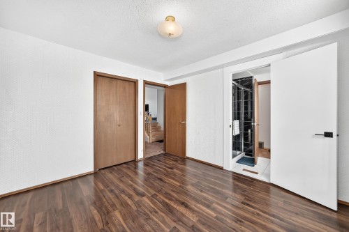 Room featuring wood-finish flooring, white walls, and a ceiling light fixture - 1928 68 Street Nw, Edmonton, AB - Indoor Photo Showing Other Room