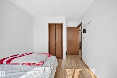 Room featuring wood-finish flooring, white walls, and a white ceiling - 1928 68 Street Nw, Edmonton, AB - Indoor Photo Showing Bedroom