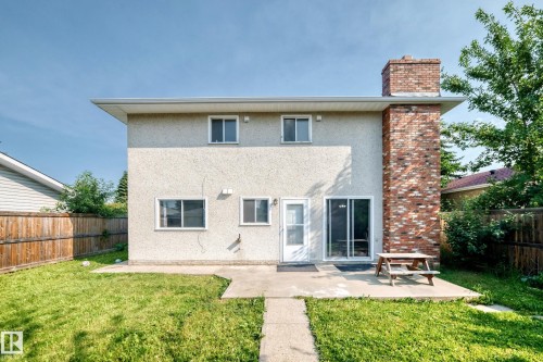 Stucco exterior with a prominent brick chimney - 1928 68 Street Nw, Edmonton, AB - Outdoor