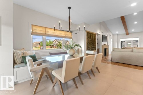 Dining area featuring a built-in window bench, a linear chandelier, and tile flooring - 2503 Lockhart Way, Cold Lake, AB - Indoor Photo Showing Dining Room