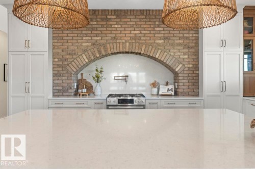 Spacious kitchen island featuring a quartz light-toned countertop - 2503 Lockhart Way, Cold Lake, AB - Indoor Photo Showing Kitchen