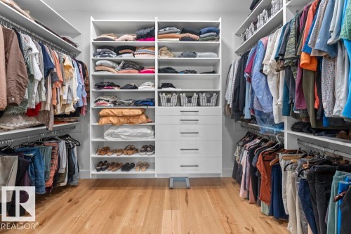 Custom closet system with extensive shelving, multiple hanging rods, and built-in drawers - 2503 Lockhart Way, Cold Lake, AB - Indoor With Storage