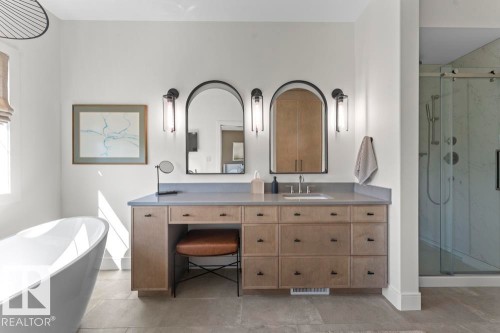 Spacious bathroom featuring a double vanity with a light wood-finish cabinet and grey countertop - 2503 Lockhart Way, Cold Lake, AB - Indoor Photo Showing Bathroom