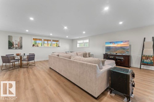 Spacious recreation area featuring wood-finish flooring, recessed lighting, and white baseboards - 2503 Lockhart Way, Cold Lake, AB - Indoor