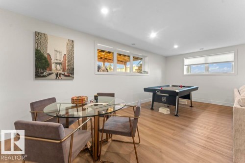 Finished lower-level space featuring recessed lighting, wood-finish flooring, and multiple windows providing natural light - 2503 Lockhart Way, Cold Lake, AB - Indoor Photo Showing Dining Room