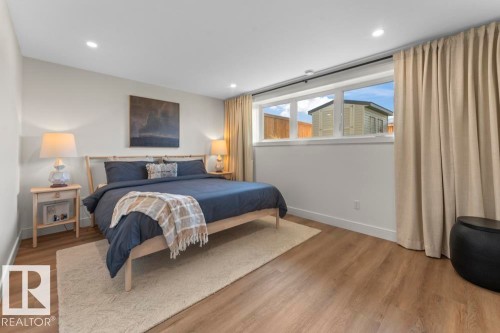 Bedroom featuring light wood-finish flooring, recessed lighting, and a wide window with white trim - 2503 Lockhart Way, Cold Lake, AB - Indoor Photo Showing Bedroom