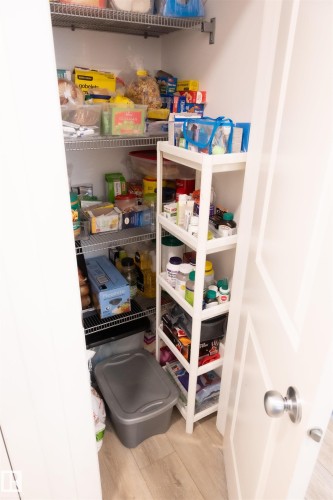 Pantry featuring multiple wire shelving units - #103 860 Secord Bv Nw, Edmonton, AB - Indoor With Storage