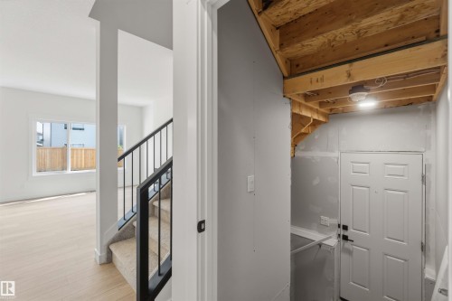 Interior staircase with black metal railings and carpeted treads - 5872 Raven Crescent Nw, Edmonton, AB - Indoor Photo Showing Other Room